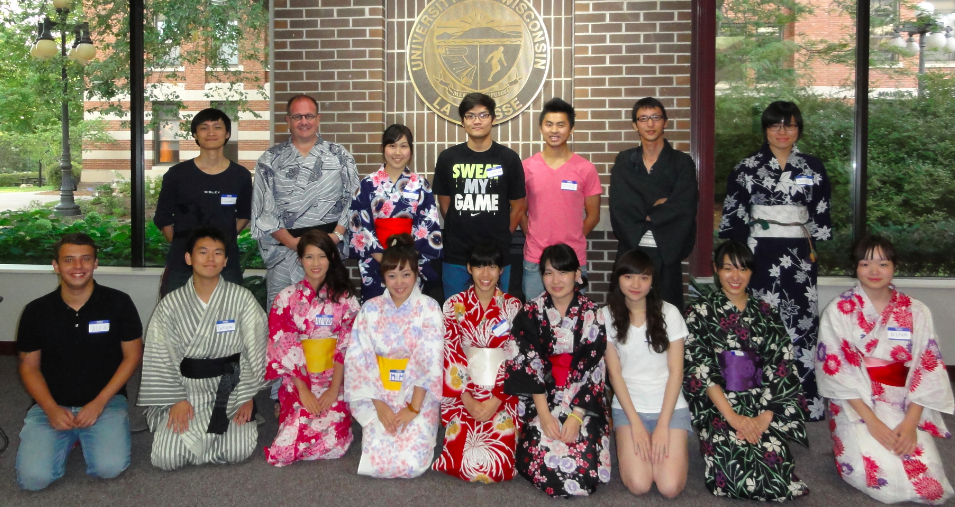 Image of Japanese students in their traditional dress posing for a picture with several UW-L students. 