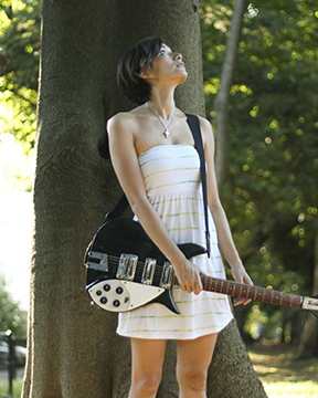 Kat McDowell holding a guitar