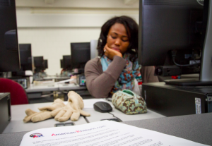 Image of a student sitting at her computer. 