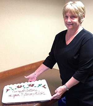 Photo of Lois Stuhr with cake.