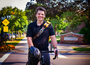 Image of James Longhurst on his bike - standing near the UW-L campus. 