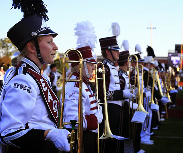 Image of trombone players lined up. 