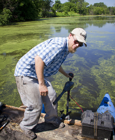 Ryan Perroy, UW-L assistant professor of geography, sets up equipment used to collect soil samples on the La Crosse River marsh. 