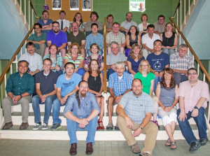 Image of all thirty teachers sitting on the steps in Cowley Hall.