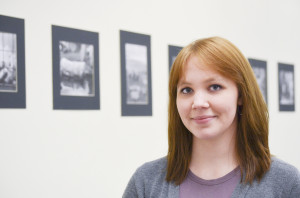 Megan Jensen standing in front of her artwork.