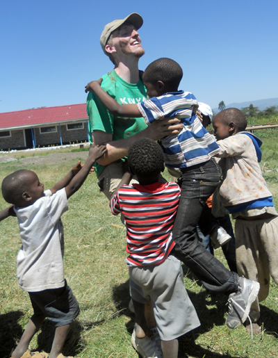 UW-L student Mike Wilson plays with kids at an elementary school in Kenya. 