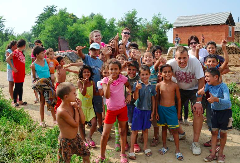 Peter Molnar pictured with kids in the Romanian slum.