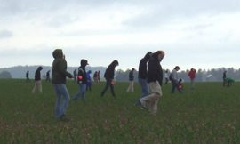 People walking through a field on a previous archaeological survey.