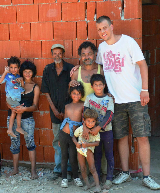 Some of the family members in the Romanian ghetto pictured in front of the new house UW-L student Peter Molnar built.