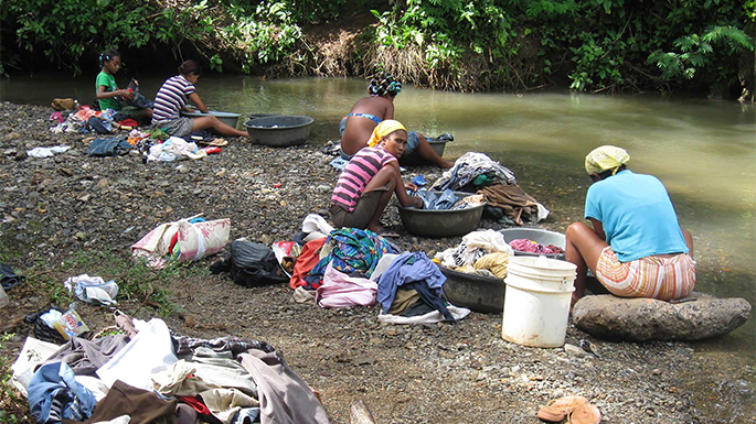 How does global inequality affect perceptions and practices related to conservation and the environment? Sometimes, whole families migrate so that a family member can work in the wage economy. While their male partners and sons work as migrant farmers, these women work to earn cash by washing other people's clothes and are paid by the piece. They don't have washing machines in their homes, due to lack of running water, so they wash these clothes in the nearby river. In order to survive, these women use a utilitarian framework of their environments, and the resulting pollution in the river is an externality, or by-product, of a survival strategy. Therefore, in order to conserve environments, people don't need education about conserving environments, they need to be able to meet their basic needs.