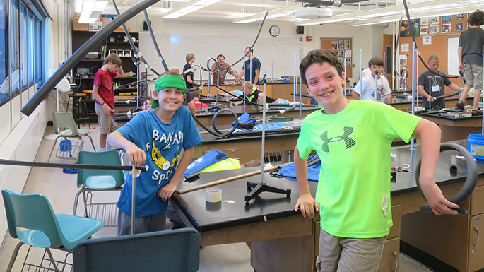 Boys design roller coasters and learn about the scientific principles that govern their designs in a workshop taught by Seth King.