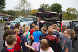 UWL Chancellor Joe Gow meets students at his vehicle to unload supplies.