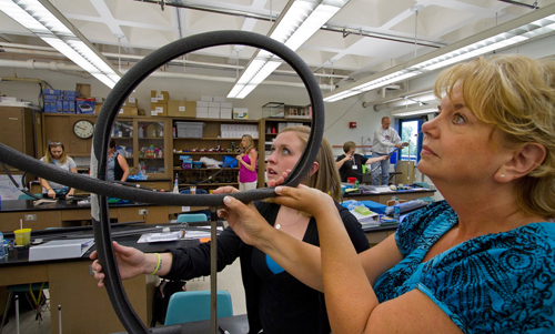 Teachers in grades 3-10 construct mini rollercoasters in a UW-L science lab with help from university faculty.