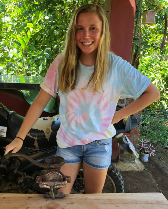 UWL student Savannah Stanley grinding cacao beans during her visit to Costa Rica.