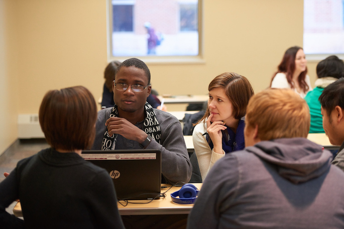 Students working together at a table in an SAA class. 