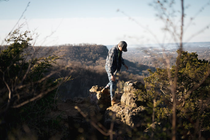 UWL Junior Jack Schickel walking over rocks at Grandad Bluff.