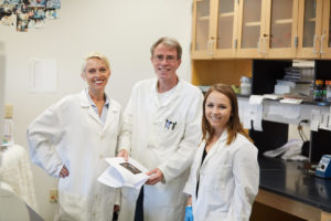 Zank, Schwan and Schulte pose for the camera in the lab.