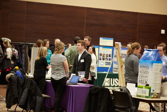 Students talking to employers at tables during the Science Career Forum in 2017.