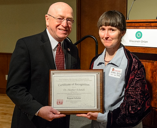 Image of Heather posing with the award with UW System President Ray Cross. 