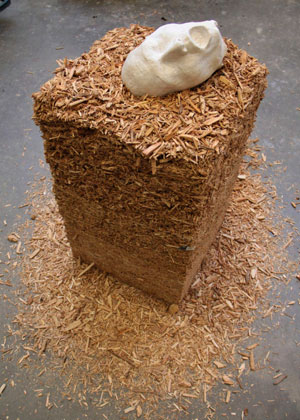 Bale of hay with artwork face on top.