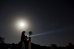 Image of projector screening at night. 