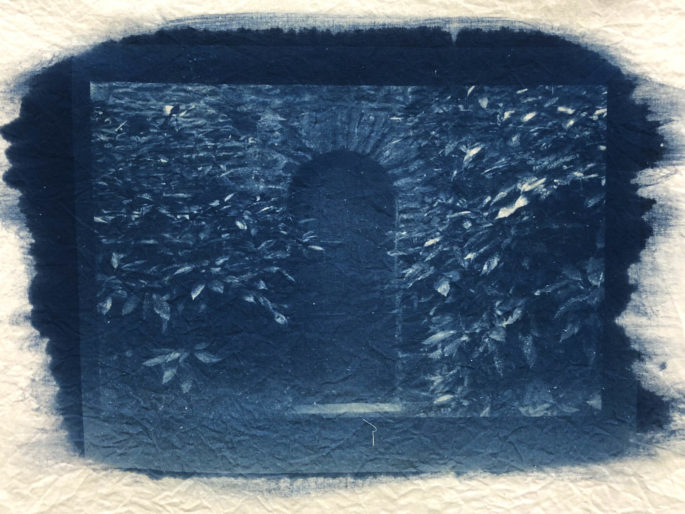 A picture of a door on fabric, with cyanotype as it's medium-producing a deep blue color.