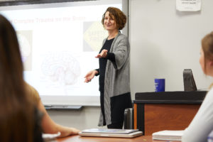 DeBoer lectures in front of class