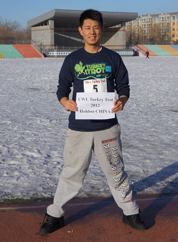 Yutong Bo standing on the track at his high school in China.