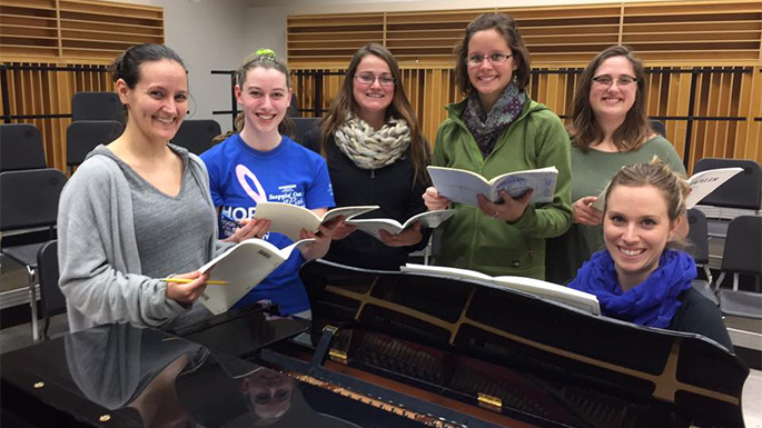 Members of the UWL Choral Union preparing for the university-community ensemble's concert Sunday, Dec. 11, including the soloists for Vivaldi’s “Gloria,” from left, Kelsey Taunt, Kari Willett, Erin Schockmel, Emily Post and Allison Langer. Choral Union accompanist Alethia Kenworthy-Williquette is seated at the piano.