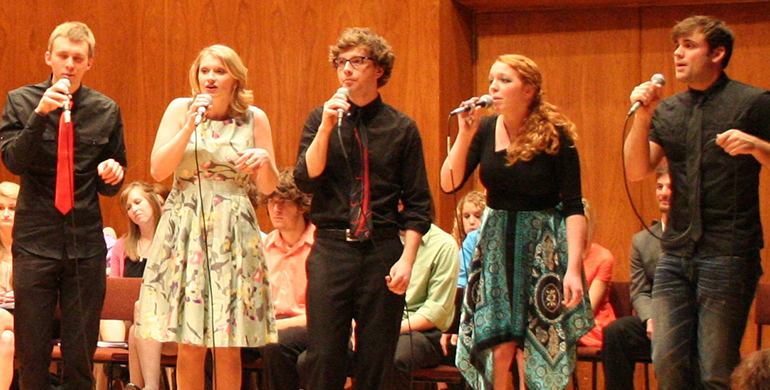 Photo of group singing. 