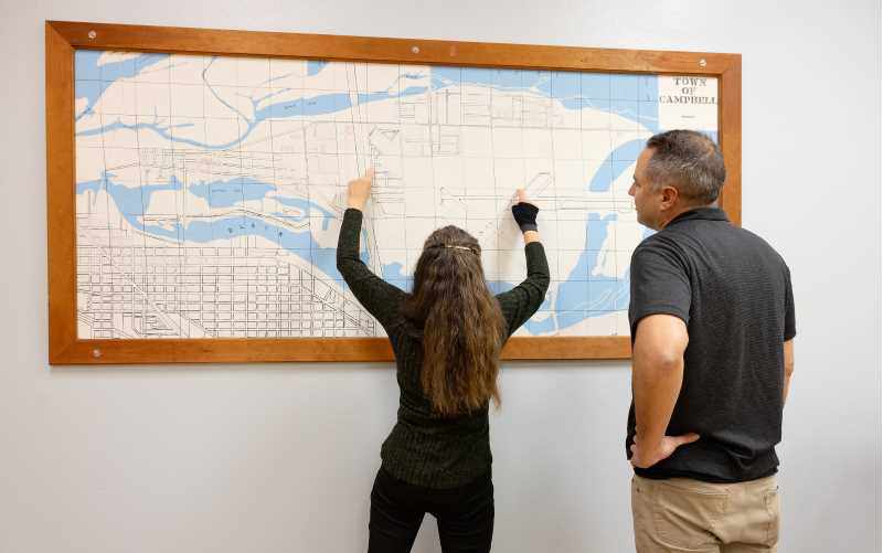 Lee Donahue, a Town of Campbell supervisor, and Brian Pompeii, UW-La Crosse assistant professor of Geography & Environmental Science, review a Town of Campbell map.