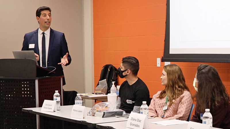 UWL Assistant Professor of Spanish Antonio Martín Gómez, left, speaks during an event at the La Crosse Area YMCA where students showcased their work.