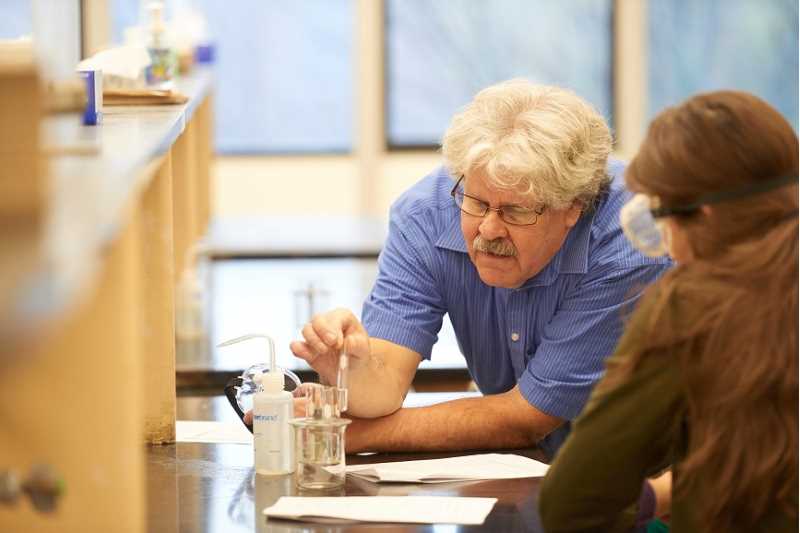 Concurrent Enrollment student and teacher in a science lab