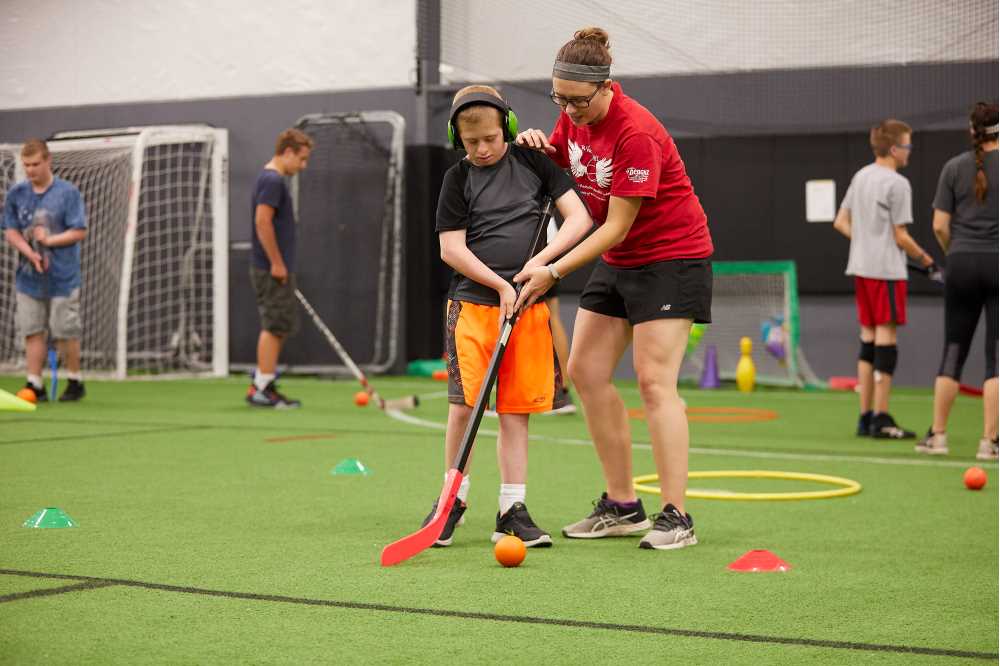 Youth and student play floor hockey