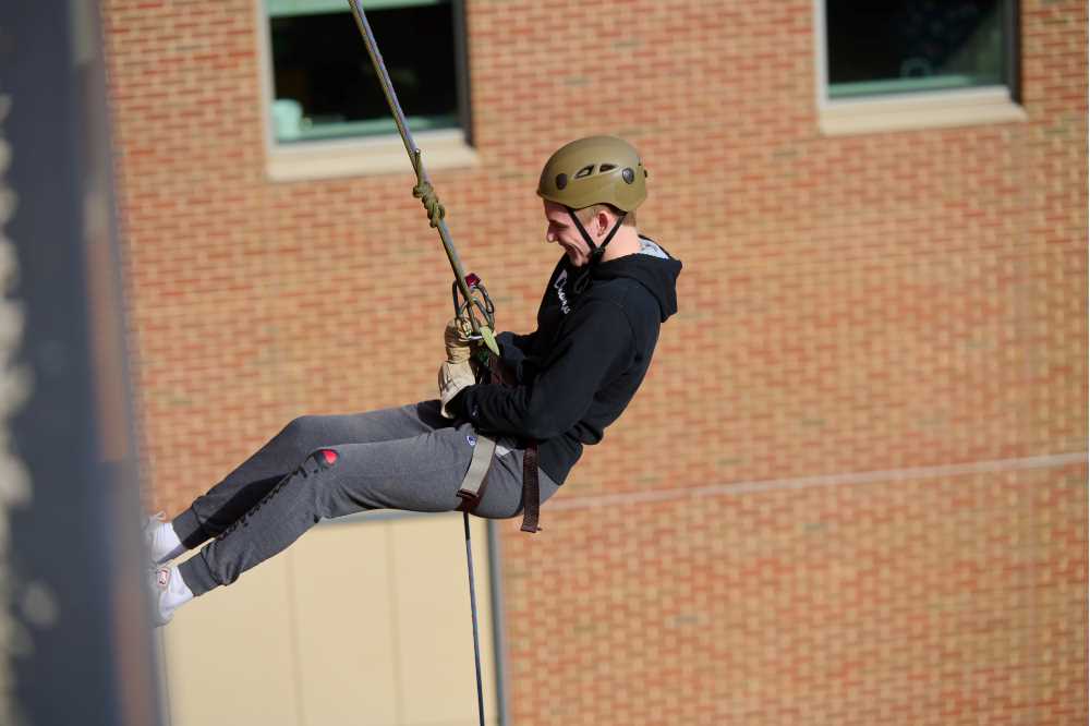 Student rappelling off UWL building